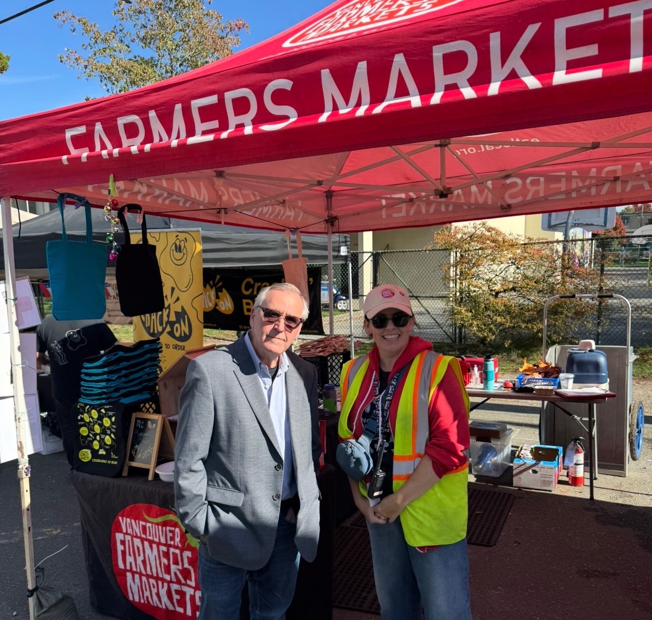 John standing at a Farmers Market table