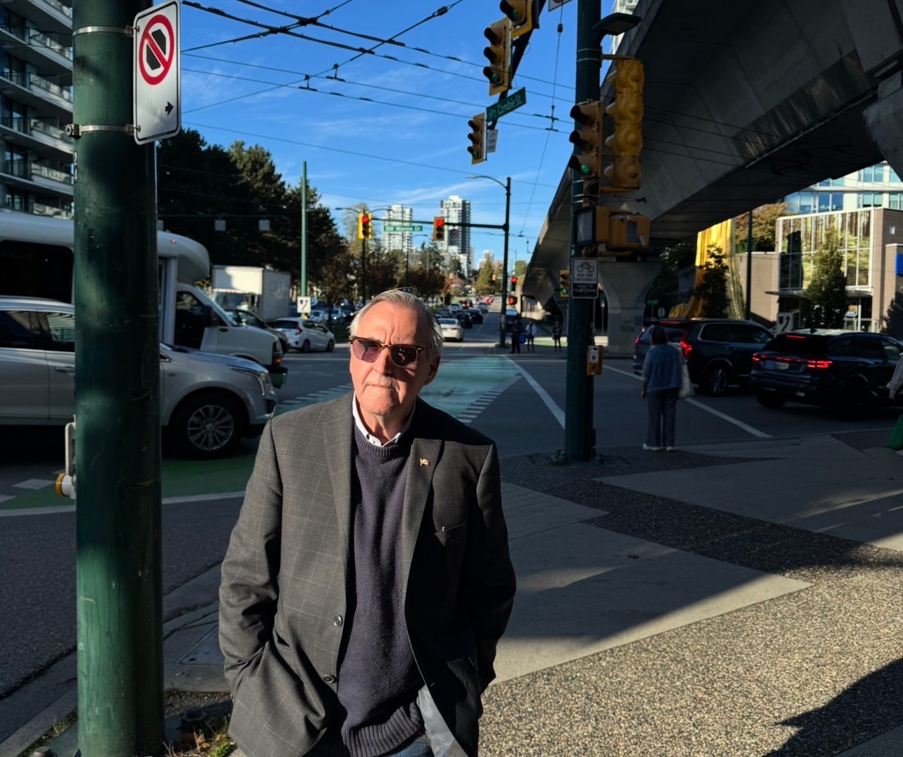 John standing on a busy street in Marpole