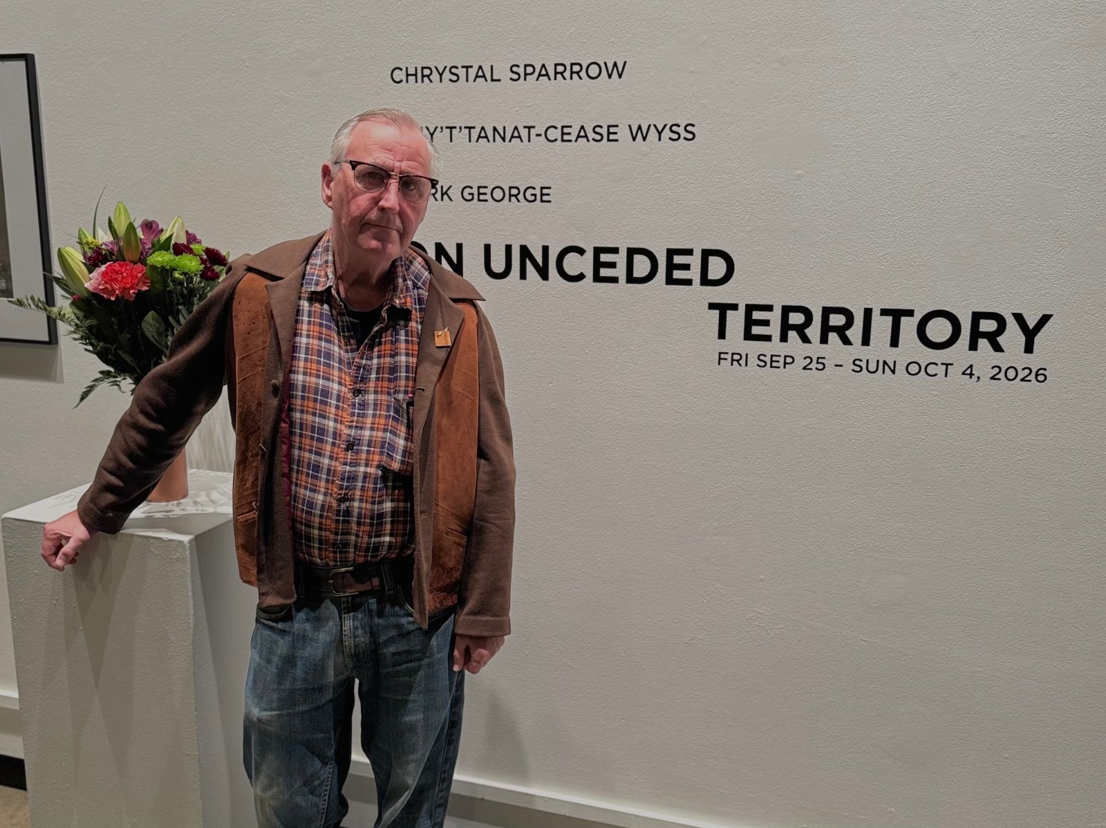John Jones, standing in front of the 'On Unceded Territory' exhibit entrance.