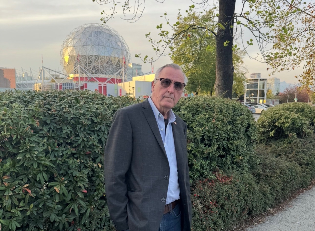 John standing in front of Science World